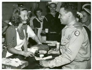 Actress Bette Davis serves cake at the Stage Door Canteen in 1943. The Canteen was located in the Belasco Theater on Lafayette Square, across from the White House.