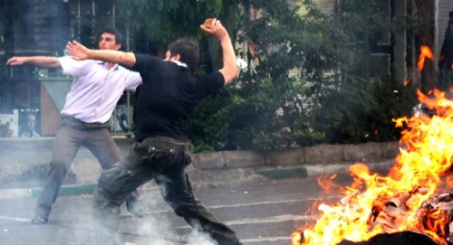 Supporters of Iran's defeated presidential candidate Mir Hossein Mousavi throw stones at riot police during a demonstration in Tehran on June 20, 2009. Thousands of Iranians clashed with police as they defied an ultimatum from supreme leader Ayatollah Ali Khamenei for an end to protests over last week's disputed presidential election. 